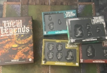 A photo of the Epic Encounters: Local Legends Tavern Kit and four encounter boxes sitting on a gaming mat.
